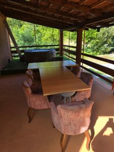 a wooden table and chairs in a room at Premecki konak in Čačak