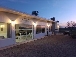 a white building with windows and tables in it at La Martinna 1 in Trinidad