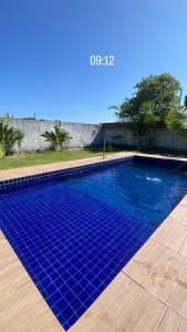 una piscina con azulejos azules en el suelo en Chácara recanto do girassol, en Aquiraz