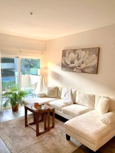a living room with a couch and a table at Luxury Hollywood Stay Beautiful 2Beds2Baths in Los Angeles