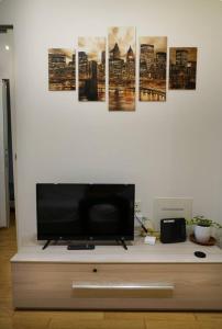 a living room with a tv on a white wall at centro di rho - rho fiera - vicino stazione in Rho