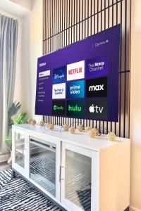 a tv screen on a wall in a living room at The 708 - For 4 - Free Parking - BBQ in Quebec City