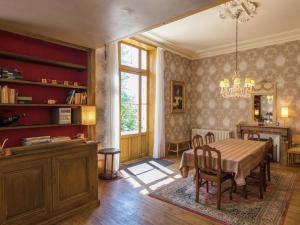 a dining room with a table and a window at Manoir La Peyrade in Brouchaud