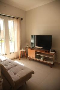 a living room with a large flat screen tv at La Casa Lagoinha in Tigre