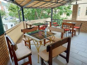 a group of tables and chairs on a patio at Vila Kastriotet-Hotel in Lezhë