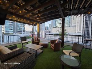 a living room with chairs and couches on a balcony at Excepcional Apartamento en Ave Balboa N#4 in Panama City