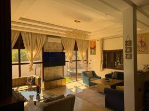 a living room with a couch and a table at Villa Tikida - Paradise Valley in Aksri
