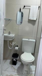 a small bathroom with a toilet and a sink at Pousada Querência Porto de Galinhas in Porto De Galinhas +11 photos