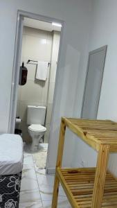 a small bathroom with a toilet and a mirror at Pousada Querência Porto de Galinhas in Porto De Galinhas