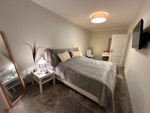 a bedroom with a bed and a table with a mirror at Modern, Gemütlich, Strandnah in Cuxhaven +4 photos