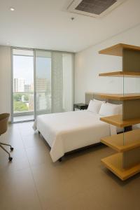 Ένα ή περισσότερα κρεβάτια σε δωμάτιο στο Distrito 90 Suites