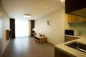 a room with a kitchen and a living room at Best Western Haeundae Hotel in Busan