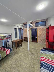 a room with two bunk beds and a table at Guesthouse "Pines" in Urekis Sadguri