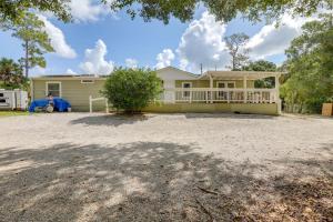 a house with a large driveway in front of it at Family-Friendly Palm City Home 14 Mi to Beach! in Palm City