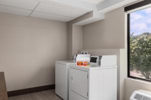 a room with a refrigerator and a window at Holiday Inn Express Fayetteville Fort Bragg by IHG in Fayetteville