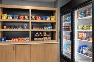 a refrigerator filled with lots of food and drinks at Holiday Inn Express Fayetteville Fort Bragg by IHG in Fayetteville +33 photos