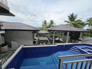 a swimming pool on the side of a house at Eagles Nest Beach Resort Room 2 in Samal