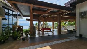 a house with a patio with a view of the ocean at Eagles Nest Beach Resort Room 3 in Samal