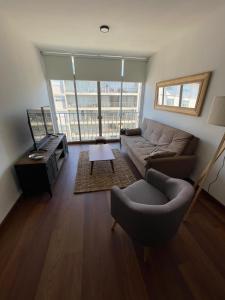 a living room with a couch and a table at Frente al mar in Montevideo