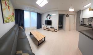 a living room with a couch and a table at Nangman Yeosu in Yeosu