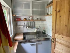 a small kitchen with a sink and a counter at 4 person holiday home in DEGEBERGA in Degeberga