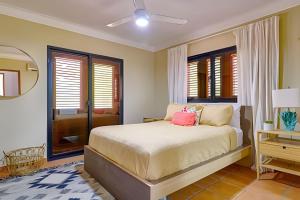 a bedroom with a bed and a mirror at Caribbean Idyllic Vacation at Beachfront 1-BR Apt. in Juan Dolio +26 photos