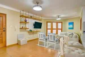 a living room with a couch and a table at Caribbean Idyllic Vacation at Beachfront 1-BR Apt. in Juan Dolio