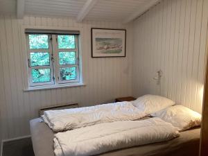 Una cama o camas en una habitación de Sauna Retreat in Blabjerg - By Traum Ferienwohnungen