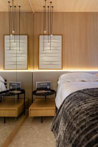 a bedroom with two side tables and two beds at Luxo na rua mais icônica do Itaim Bibi in Sao Paulo +44 photos