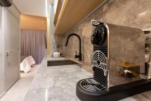 a bathroom with a sink and a towel rack at Luxo na rua mais icônica do Itaim Bibi in Sao Paulo