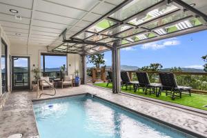 an indoor swimming pool with a patio with a view at 5 Suites - 180 View - Pool-Spa-Theater - Fireplace in Sevierville