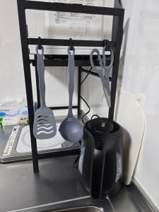 a shelf with two utensils in a refrigerator at 通天閣徒歩1分3ベッド in Osaka