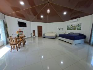 a bedroom with two beds and a table and chairs at Taw K'a Cabañas 