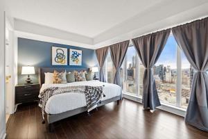 a bedroom with a bed and a large window at Yonge and Dun condo in Toronto