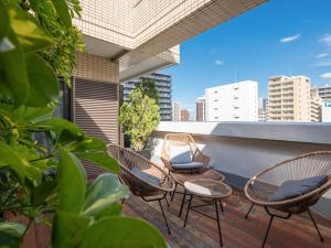 a group of chairs sitting on a balcony at Hotel Tokyo Trip Ueno Nishi Nippori in Tokyo