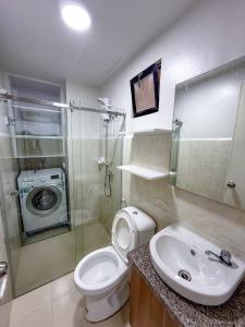 a bathroom with a toilet and a sink and a shower at Urban Chic Home Urban Chic Home with balcony in Pajo