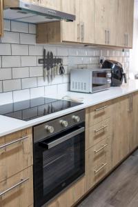 a kitchen with a stove and a microwave at Central Modern 2 Bedroom - Bergrivier Hideaway in Velddrif