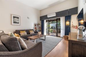 una sala de estar con un sofá y una mesa en TreeTops Margaret River, en Margaret River Town