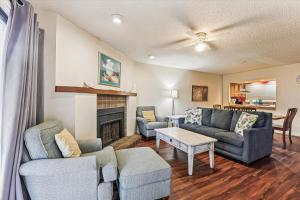 a living room with a couch and chairs and a fireplace at Beachfront Bliss Fun in St Augustine in Saint Augustine