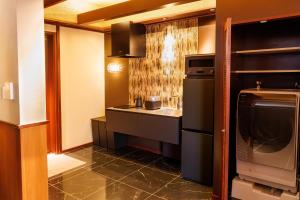 a kitchen with a sink and a stove top oven at Miyakojima Kurima Resort Seawood Hotel in Miyako-jima