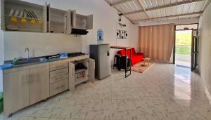 a kitchen with a sink and a red chair at OSIMiRI CUERVOS in San Rafael