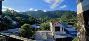 a view of a village with mountains in the background at Hùng Cúc homestay in Tân Hiệp