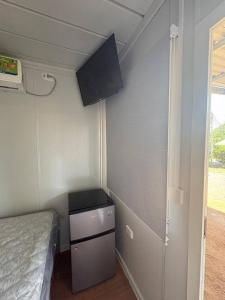 a small room with a bed and a small dresser at Cabinas Nena in Esparza