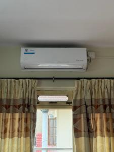 a air conditioner above a window in a room at Home Guest House in Kathmandu +1 photo