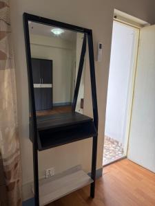 a mirror on a stand in a room at Home Guest House in Kathmandu