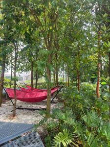 a red boat sitting in the middle of trees at Gamuda Sky Luge Maryam Homestay in Rawang