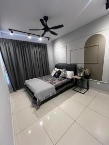a bedroom with a bed and a ceiling fan at Gamuda Sky Luge Maryam Homestay in Rawang +6 photos