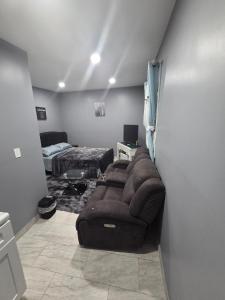 a living room with a couch and a bed at Newly built Studio Close to NYC and EWR in Irvington