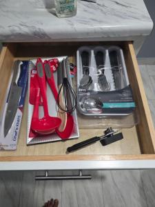 a drawer with scissors and other kitchen utensils at Newly built Studio Close to NYC and EWR in Irvington