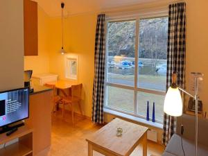 a living room with a large window and a table at 3 person holiday park home, Lærdal in Lærdalsøyri
